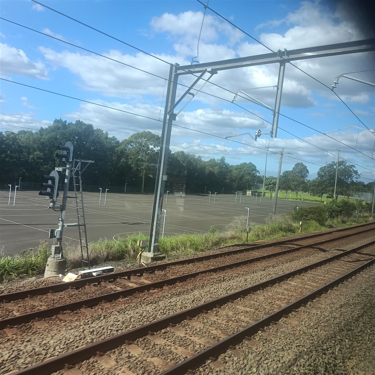 Blacktown Peace Park courts and open space beyond railway tracks